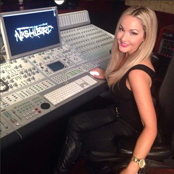 Aria Johnson sits at the mixing board in Nightbird Studios in Los Angeles